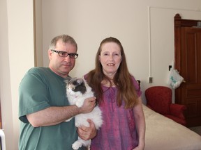 Eldon Greencorn and Wendy Ziegler, with their cat Patches, inside a suite at Park Place Retirement Residence, where they are staying for free while they wait to figure out when they can return to Fort McMurray. The couple said they are so grateful for the warm welcome at Park Place. (MEGAN STACEY/Sentinel-Review)