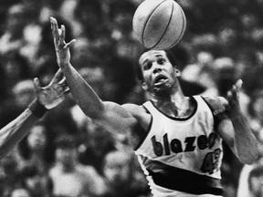In this Dec. 25, 1979, file photo, Portland Trail Blazers'  Kermit Washington gains control of a loose ball during an NBA basketball game against the Golden State Warriors in Portland, Ore. (AP Photo/Jack Smith, File)