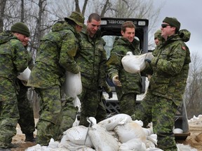 Assinboine River. Sandbagging. Soldiers. Flood.