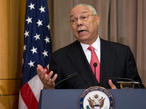 In this photo taken Sept. 3, 2014, former Secretary of State Colin Powell speaks at the State Department in Washington. The Romanian hacker known as Guccifer, who is charged with breaking into computer accounts of the Powell, the Bush family, and others, has been brought to the U.S. to face criminal charges. (AP Photo/Carolyn Kaster)