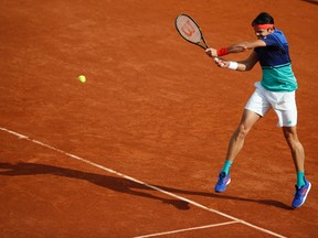 Canada's Milos Raonic returns the ball to France's Adrian Mannarino during the second round of the French Open in Paris on Wednesday, May 25, 2016. (Alastair Grant/AP Photo)