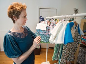 Louise Howard shows off the baby accessories she makes from her home in Montreal. Howard is one of a growing number of Canadians working from home.