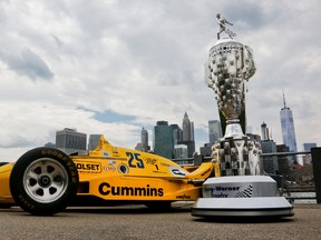 The Borg-Warner race trophy for the winner of the Indianapolis 500, right, is displayed next to iconic Indy cars during a promotional event, Tuesday May 24, 2016, in New York. The 100th running of the Indianapolis 500 auto race is scheduled for Sunday. (AP Photo/Bebeto Matthews)