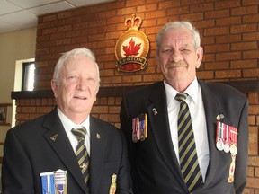 Allan Jones, left, president of Royal Canadian Legion Branch 560, and Merrill Gooderham, chairman of the branch's Poppy Fund, gather at the Legion in Kingston, Ont. on Wednesday, May 25, 2016 to announce a donation of $20,000 to help with disaster relief in Fort McMurray. Michael Lea The Whig-Standard Postmedia Network