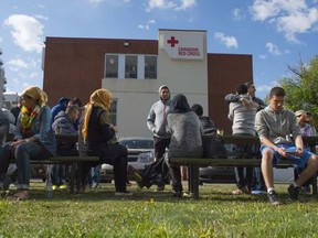 Evacuees from the Fort McMurray wildfire wait outside the Red Cross building in downtown Edmonton on May 11, 2016. Shaughn Butts / Postmedia