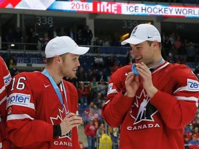 Max Domi, left, and Kingston’s Taylor Hall hold their gold medals following Canada’s 2-0 win over Finland in the final at the World Hockey Championship in Moscow on Sunday. (Maxim Shemetov/Reuters)