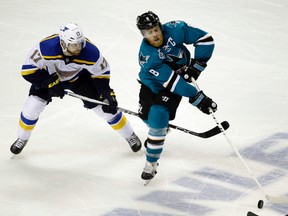 Sharks captain Joe Pavelski (8) reaches for the puck as Blues' Jaden Schwartz (17) defends during the third period in Game 4 of the NHL's Western Conference final in San Jose, Calif., on May 21, 2016. (Marcio Jose Sanchez/AP Photo)