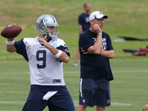 Dallas Cowboys quarterback Tony Romo throws as offensive coordinator Scott Linehan looks on during organized team activities at Dallas Cowboys Headquarters. (Matthew Emmons/USA TODAY Sports)