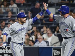 Toronto Blue Jays catcher Russell Martin, left, is greeted by Justin Smoak after hitting a two-run home run against the New York Yankees Wednesday, May 25, 2016, in New York. (AP Photo/Julie Jacobson)