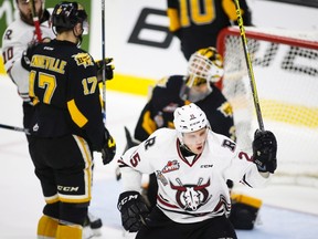 Brandon Wheat Kings' John Quenneville, left, and goalie Jordan Papirny look on as Red Deer Rebels' Adam Musil, centre, celebrates his tying goal during third period Memorial Cup hockey action in Red Deer, Wednesday. (THE CANADIAN PRESS)