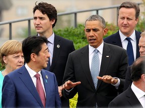 Japanese Prime Minister Shinzo Abe, centre, chats with U.S. President Barack Obama, fifth left, as other leaders of Group of Seven industrial nations, from left, Italian Prime Minister Matteo Renzi, German Chancellor Angela Merkel, Abe, Canadian Prime Minister Justin Trudeau, top, Obama, British Prime Minister David Cameron and European Council President Donald Tusk, walk along after a family photo session on the first day of the G7 summit meetings in Shima, Japan, Thursday, May 26, 2016. (Japan Pool via AP)