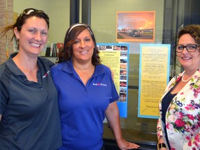 First Student Canada bus drivers Kate Hamilton, left, Sandy Bond and St. Thomas branch manager Janice White are spreading the word about a fundraising barbecue and garage sale on June 18. Money raised from the Talbotville rummage sale will support the 30 First Student Canada bus drivers who have been forced from their homes in Fort McMurray because of the historic wildfires in the area.