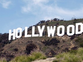 This file photo taken Friday Jan. 29,2010, shows the Hollywood sign near the top of Beachwood Canyon adjacent to Griffith Park in the Hollywood Hills of Los Angeles. KTLA-TV reported Wednesday, May 25, 2016, that YouTube prankster Vitaly Zdorovestskiy was arrested after climbing the sign. (AP Photo/Reed Saxon, File)