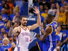 In this Sunday, May 22, 2016 photo, Golden State's Draymond Green's leg is between the legs of Oklahoma City's Steven Adams (12) during Game 3 of the Western Conference NBA basketball  finals in Oklahoma City. (Bryan Terry/The Oklahoman via AP)