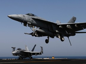A F/A-18E Super Hornet lands onboard the aircraft carrier USS George H.W. Bush in the Persian Gulf August 12, 2014.  Two U.S. Navy F/A-18 jets collided while airborne on Thursday off the North Carolina coast, and all four crew members were recovered safely, U.S. officials said. REUTERS/Hamad I Mohammed/File Photo