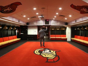 Ottawa Senator Chris Phillips visits his old dressing room after a press conference at Scotiabank Place in Ottawa on May 26, 2016. (Tony Caldwell/Postmedia)