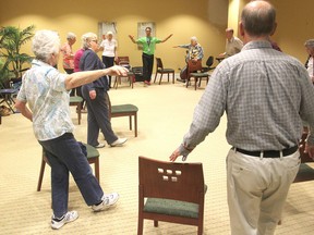 Fitness instructor Mark Wittmann, in green shirt, leads an exercise class for seniors in a retirement residence in Kingston designed to improve their balance. It is run by the Victorian Order of Nurses. (Michael Lea/The Whig-Standard)