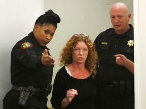 Deputies direct Tonya Couch (C) to the defence table before her bond reduction hearing in Criminal District Court in Fort Worth, Texas, U.S. January 11, 2016. REUTERS/David Kent/Ft. Worth Star-Telegram/Pool/File Photo