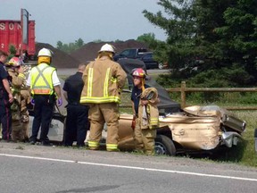 Emergency services respond to a collision between a vintage convertible and a farm tractor on Joyceville Road in Kingston, Ont. on Thursday May 26, 2016. Frontenac Paramedic Service