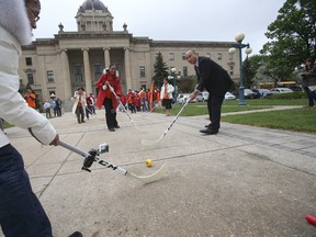 About 30 local workers played a short game of ball hockey behind the Legislature on Thursday and gathered to raise awareness of the potential for lost jobs here and across Canada.