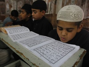 Pakistani Muslim students attend a religious madrassa, or school, to learn the Quran, in Peshawar, Pakistan, Tuesday, May 17, 2016. Religious schools in Pakistan, most of them in mosques are the only source of education for thousands of children. (AP Photo/Mohammad Sajjad)