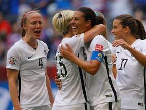 Carli Lloyd  of the United States celebrates after her third goal against Japan with Megan Rapinoe in the FIFA Women's World Cup Canada 2015 Final at BC Place Stadium on July 5, 2015 in Vancouver, Canada. (Kevin C. Cox/Getty Images/AFP)