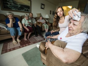 Sabina Ochnik (R) is comforted by her granddaughter, Christa Ochnik, in her TCH seniors'  apartment. (CRAIG ROBERTSON, Toronto Sun)