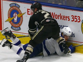 Marlies’ William Nylander gets run into the boards by the Bears’ Tyler Lewington in Game 3 of the Eastern Conference final. (Dave Abel/Toronto Sun)