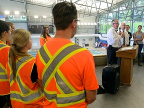 Ontario Labour Minister Kevin Flynn talks to young city workers about job safety with London Mayor Matt Brown at the Canada Games Aquatic Centre Thursday. The city employs hundreds of young people every summer. (MORRIS LAMONT, The London Free Press)