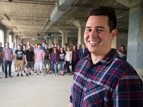 Northern Commerce chief executive Mike DeLorenzi stands inside the new space with the staff behind him. (MIKE HENSEN, The London Free Press)