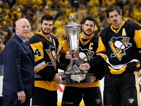 NHL deputy commissioner Bill Daly (L) presents the Prince of Wales trophy to Pittsburgh Penguins left wing Chris Kunitz (14), center Sidney Crosby (C), and center Evgeni Malkin (71) after defeating the Tampa Bay Lightning 2-1 to win the Eastern Conference Championship in game seven of the Eastern Conference Final of the 2016 Stanley Cup Playoffs at the CONSOL Energy Center May 26, 2016. (Charles LeClaire-USA TODAY Sports)