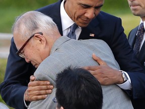 U.S. President Barack Obama hugs Shigeaki Mori, an atomic bomb survivor; creator of the memorial for American Second World War POWs killed at Hiroshima, during a ceremony at Hiroshima Peace Memorial Park in Hiroshima, western, Japan, Friday, May 27, 2016. Obama on Friday became the first sitting U.S. president to visit the site of the world's first atomic bomb attack, bringing global attention both to survivors and to his unfulfilled vision of a world without nuclear weapons. (AP Photo/Carolyn Kaster)