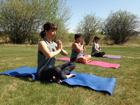 Women participate in a past Yoga in the Park event. Be Free Yoga will be hosting Community for a Cause: Yoga in the Park on June 21 to raise funds for its Be Free Project.