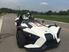 A York Regional Police officer takes the Slingshot, a new three-wheeled vehicle, out for a spin near the force's Aurora headquarters on Friday. (JENNY YUEN, Toronto Sun)