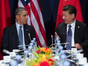 In this Nov. 30, 2015, file photo, U.S. President Barack Obama, left, meets with Chinese President Xi Jinping on the sidelines of the COP21 United Nations Climate Change Conference in Le Bourget, outside Paris, Monday, Nov. 30, 2015. By visiting Hiroshima, Barack Obama parachutes himself into a seemingly endless dispute among key U.S. allies and trading partners over World War II. In Tokyo’s decades-long tug-of-war over history with its neighbors China and South Korea, it’s the American president who could end up losing. (AP Photo/Evan Vucci, File)