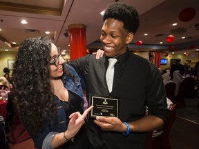 Kadre Gray (R) gets a hug from Hediyeh Karimian during a dinner to honour TCHC recipients on their Investing in Our Diversity scholarship awards on Thursday May 26, 2016. Karminian was Gray's reference. Craig Robertson/Toronto Sun/Postmedia Network