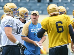 Winnipeg Blue Bombers offensive coordinator Paul LaPolice (c) speaks with players during CFL football practice in Winnipeg, Man. Wednesday May 25, 2016.