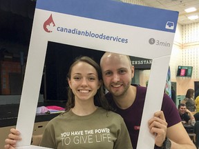 Mackenzie Curran, left, a student at Holy Cross Catholic Secondary School, is seen with Alexander Turk, the German man who helped save her life by donating stem cells that matched Curran’s, in the school’s cafeteria on Friday. Curran, with the help of Canadian Blood Services One Match stem cell and marrow network, organized a stem cell drive at the school for anyone healthy and between the ages of 17 and 35 to register for the life-saving network, as well as making an appointment to donate blood and register as an organ donor. (Julia McKay/The Whig-Standard)