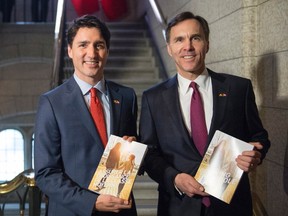 Prime Minister Justin Trudeau (left) walks with Minister of Finance Bill Morneau as he arrives to table the budget on Parliament Hill on March 22, 2016 in Ottawa. THE CANADIAN PRESS/Justin Tang