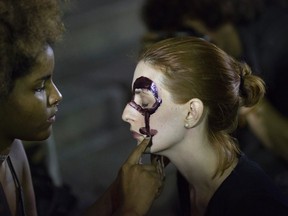 Women paint their faces with female gender symbols for a protest against the gang rape of a 16-year-old girl in Rio de Janeiro, Brazil, Friday, May 27, 2016. The assault last Saturday came to light after several men joked about the attack online, posting graphic photos and videos of the unconscious, naked teen on Twitter. (AP Photo/Leo Correa)