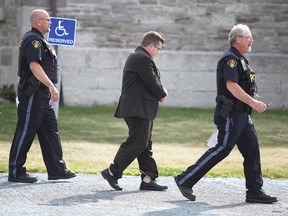 Former Stone Mills Township Ward 1 councillor and financial adviser Kevin Wagar is escorted from a Napanee courthouse in shackles and cuffs on Friday after he was remanded into custody following his sentencing hearing for fraud. (Meghan Balogh/Postmedia Network)