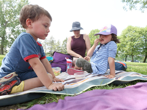 Mom Julie Nadeau and her four-year-old twins, Zachary Graton and Jessica Graton enjoy a picnic at Mooney’s Bay, where where the massive new play structure will be. (Jean Levac, Ottawa Citizen)