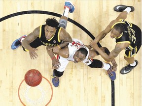 The Windsor Express? Kirk Williams Jr. gets caught between the London Lightning?s Eric Kibi and Marcus Capers during Game 6 of the National Basketball League of Canada Central Conference Final at the WFCU Centre in Windsor on Friday. The Lightning won 107-88 to win the best-of-seven series 3-2. (TYLER BROWNBRIDGE / the WINDSOR STAR)