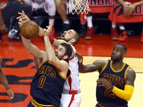 Jonas Valanciunas of the Toronto Raptors gets stopped by Kevin Love of the Cleveland Cavaliers during Game 6 of the Eastern Conference final at the Air Canada Centre in Toronto Friday May 27, 2016. (Dave Abel/Toronto Sun/Postmedia Network)