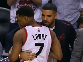 Raptors’ Kyle Lowry is greeted by rapper Drake after the Cavaliers upended the hosts 113-87 in Game 6 on Friday night at the ACC. (DAVE ABEL/TORONTO SUN)