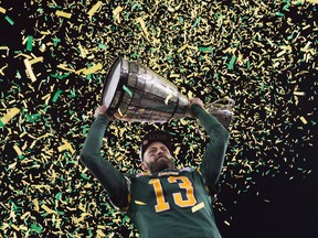 Edmonton Eskimos quarterback Mike Reilly hoists the Grey Cup after his teams win over the Ottawa Redblacks during the 103rd Grey Cup in Winnipeg, Man., Sunday, Nov. 29, 2015.