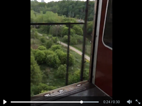 TTC subway car doors are seen open between stations over the Don Valley. (Screengrab from video)