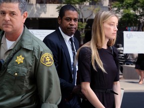 Actress Amber Heard leaves Los Angeles Superior Court court on Friday, May 27, 2016, after giving a sworn declaration that her husband Johnny Depp threw her cellphone at her during a fight Saturday, striking her cheek and eye.  (AP Photo/Richard Vogel)