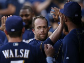 Aaron Hill is congratulated after scoring a run during Thursday's game against the Braves.(Getty Images)