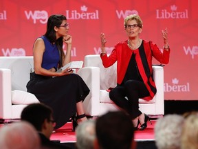 Ontario Premier Kathleen Wynne, right, speaks to Liz Plank onstage at the 2016 Liberal Biennial Convention in Winnipeg, Saturday, May 28, 2016. THE CANADIAN PRESS/John Woods